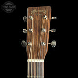 Guitar headstock with Martin & Co logo on a black background