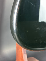 Close-up of a car side mirror with visible scratches on a blurred background