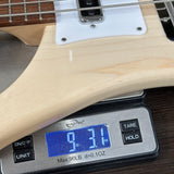 Digital scale displaying weight of a guitar neck on a wooden surface