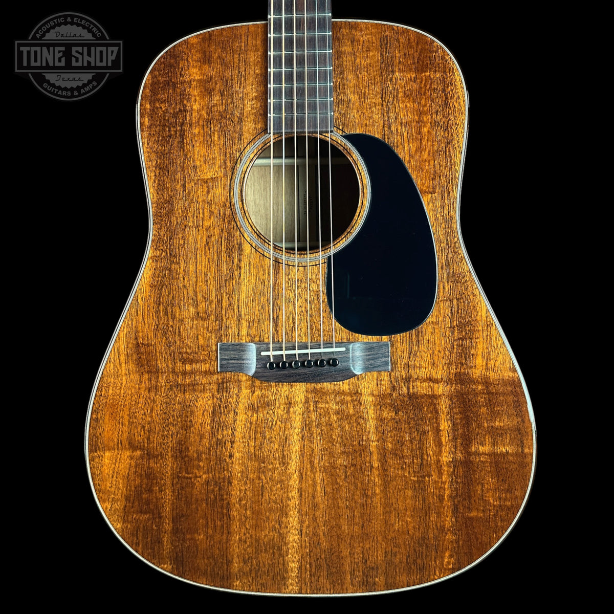 Acoustic guitar with a visible brand logo in the corner