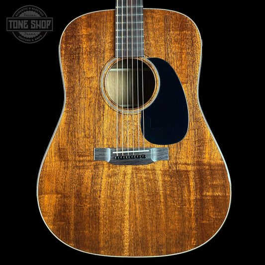 Acoustic guitar with a visible brand logo in the corner