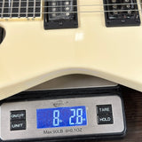 Guitar on a digital scale displaying weight