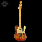 Electric guitar with a sunburst finish on a black background, featuring the Tone Shop logo.