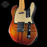 Electric guitar with a sunburst finish on a black background, featuring the Fender logo.