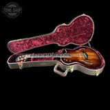 Guitar in a red case with 'Tone Shop' logo in the corner