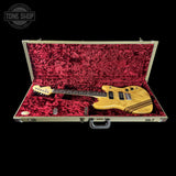 Guitar in a red-lined case with 'Tone Shop' logo.