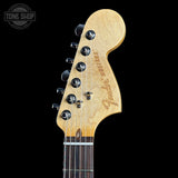 Close-up of a Fender guitar headstock on a black background