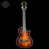 Taylor electric guitar with a dark brown finish on a black background