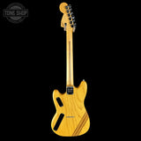 Electric guitar with a natural wood finish on a black background, featuring the Tone Shop logo.