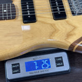 Guitar on a digital scale displaying weight