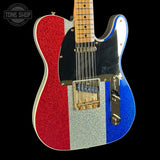 Electric guitar with red, silver, and blue glittery finish on a black background