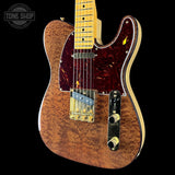 Wooden electric guitar with a visible brand logo on a black background