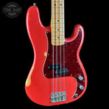 Red electric bass guitar with a black background, featuring the Tone Shop logo.