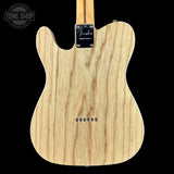 Wooden guitar body with Fender logo on a black background