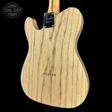 Wooden electric guitar body with Fender logo on a black background