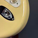 Ding on bottom edge of Used 2018 Fender Eric Johnson Thinline Strat Vintage White.