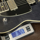 Guitar on a digital scale displaying weight