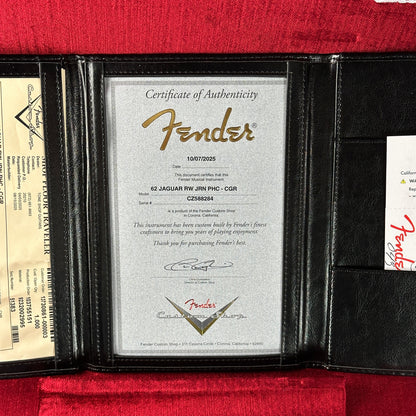Fender certificate of authenticity inside a black leather wallet on a red background
