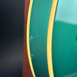 Close-up of a green reel with yellow edge on a dark background