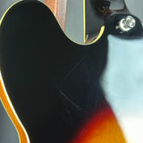 Close-up of a guitar's body with a focus on the finish and wood grain.