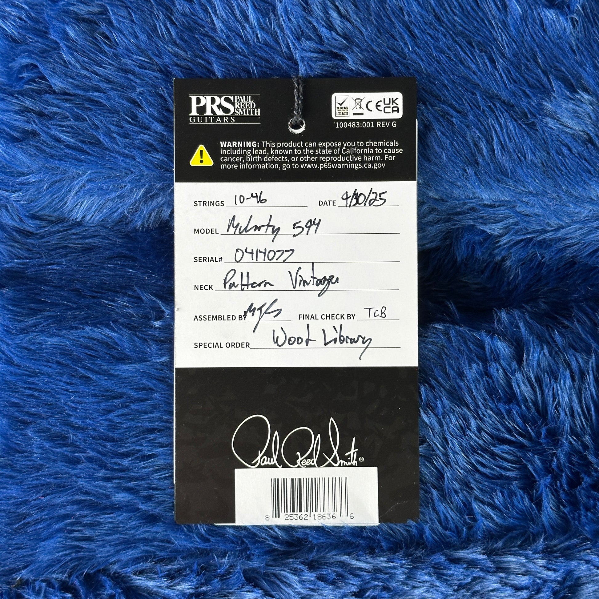 PRS Guitars label on a blue textured background