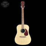 Acoustic guitar with a visible brand logo on a black background