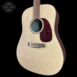 Acoustic guitar with a red soundhole on a black background, featuring the Tone Shop logo.