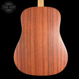 Wooden acoustic guitar back with 'Tone Shop' logo in the corner