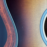 Close-up of a guitar's wooden body with a focus on the grain and texture.