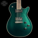 Green electric guitar on a black background with 'Tone Shop' logo.