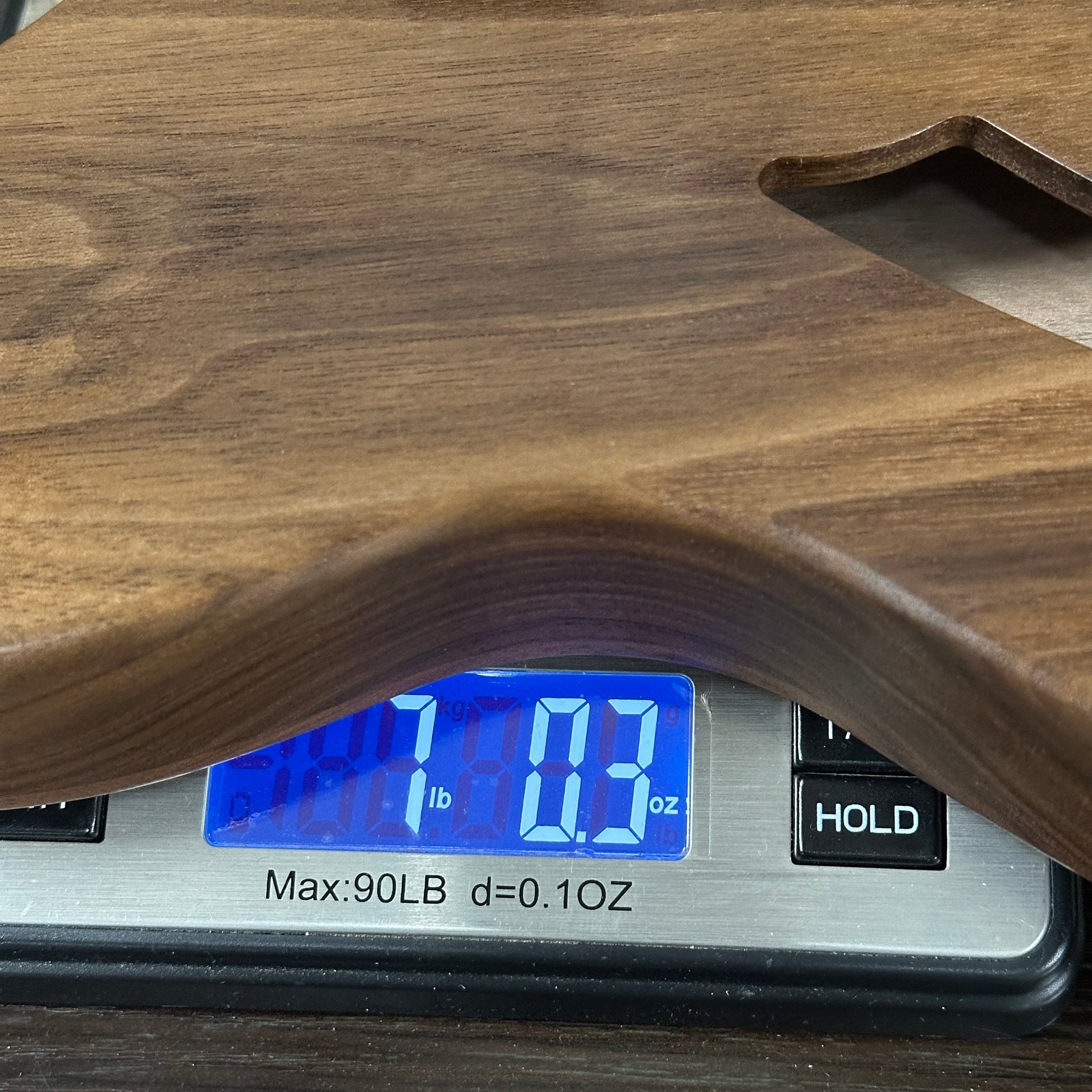 Digital scale with wooden surface displaying weight reading