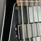 Close-up of a guitar's neck and headstock with strings.
