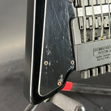 Close-up of a guitar's neck and headstock with 'Steinberger' branding.