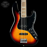 Electric bass guitar with a sunburst finish on a black background, featuring the Tone Shop logo.