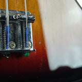 Close-up of a guitar's bridge and tuning pegs with a blurred background