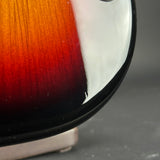 Close-up of a guitar's fretboard with a gradient color pattern on a dark background
