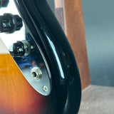 Close-up of a guitar's neck and headstock with a blurred background