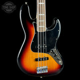 Electric bass guitar with sunburst finish on a black background, featuring the Tone Shop logo.