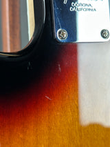 Close-up of a guitar with 'Corona California' branding on the neck