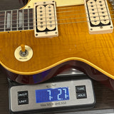 Electric guitar on a digital scale displaying weight