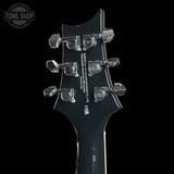 Guitar headstock with PRS branding on a black background