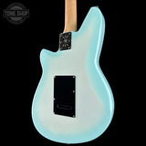 The back of a light blue electric guitar with a black pickguard and control plate, shown against a solid black background with a Tone Shop watermark in the top left corner.
