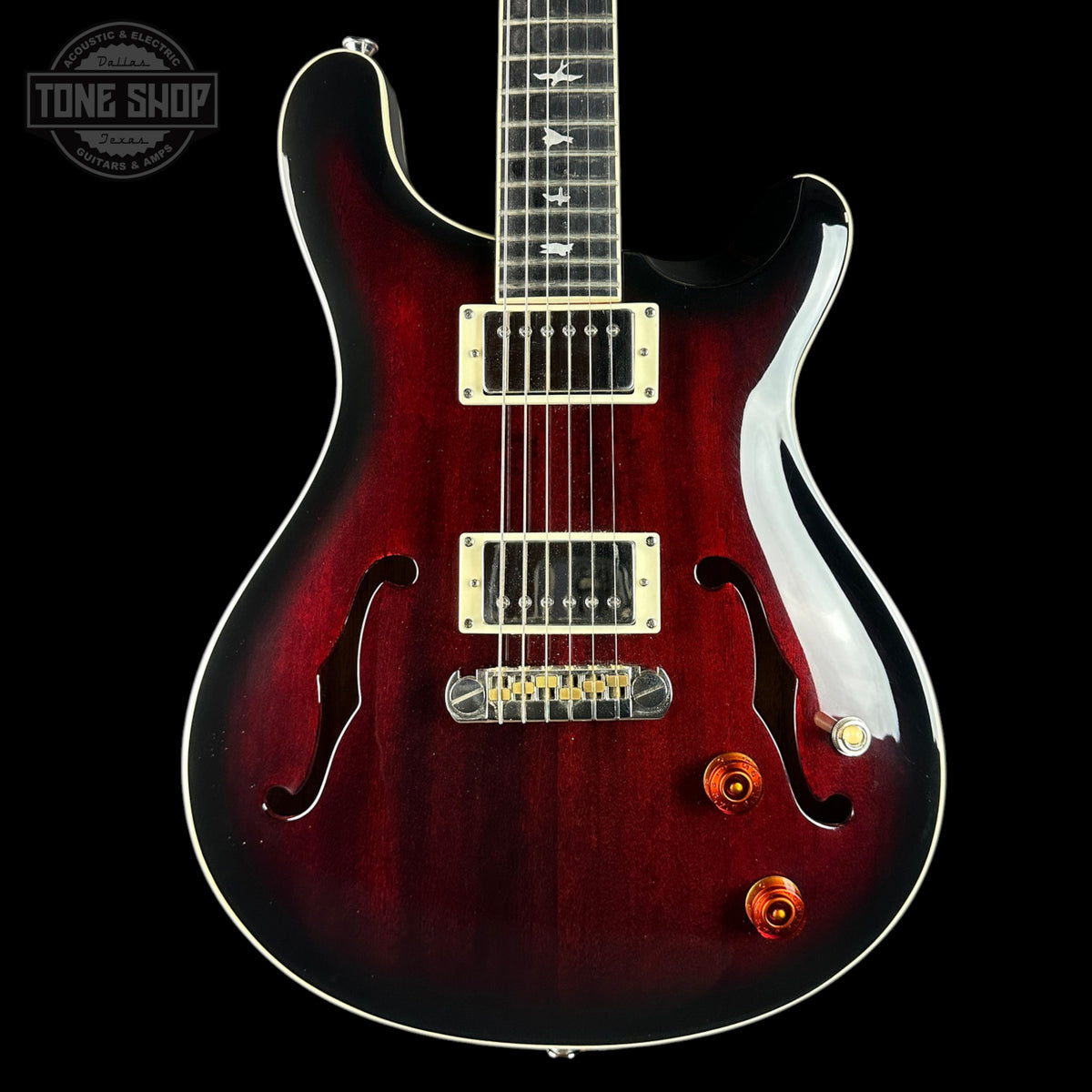 Red electric guitar with a black background
