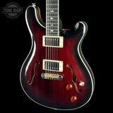 Red electric guitar with a black background