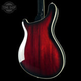 Red electric guitar body on a black background with 'Tone Shop' logo.