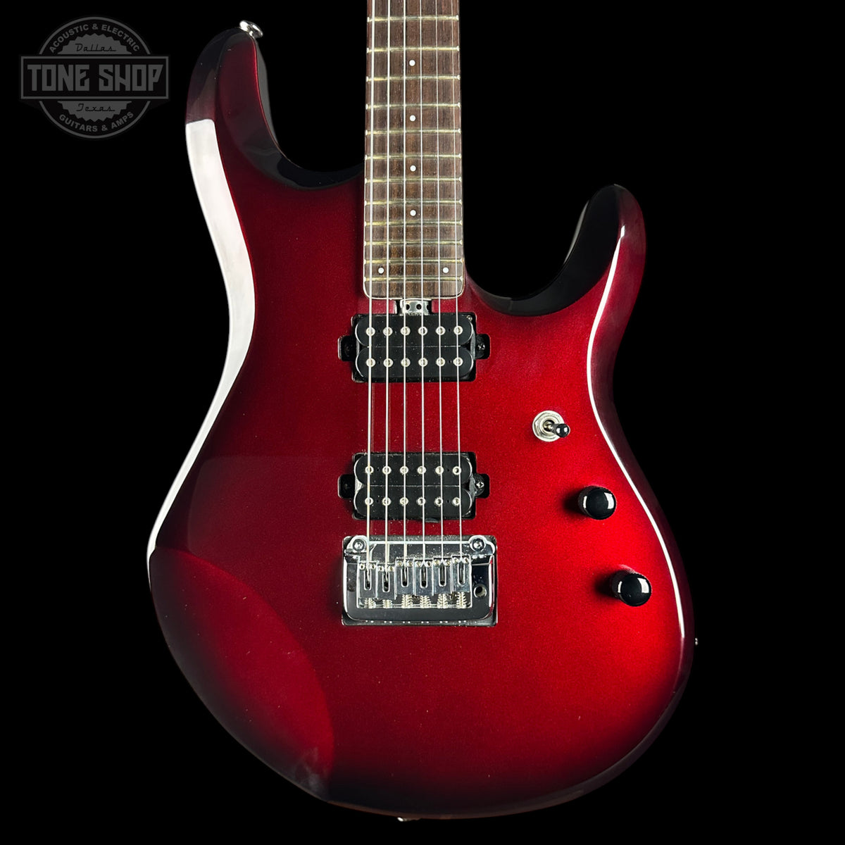 A red electric guitar with a glossy sunburst finish, featuring black hardware, a maple neck, and a chrome bridge, shown against a solid black background with a Tone Shop watermark in the top left corner.