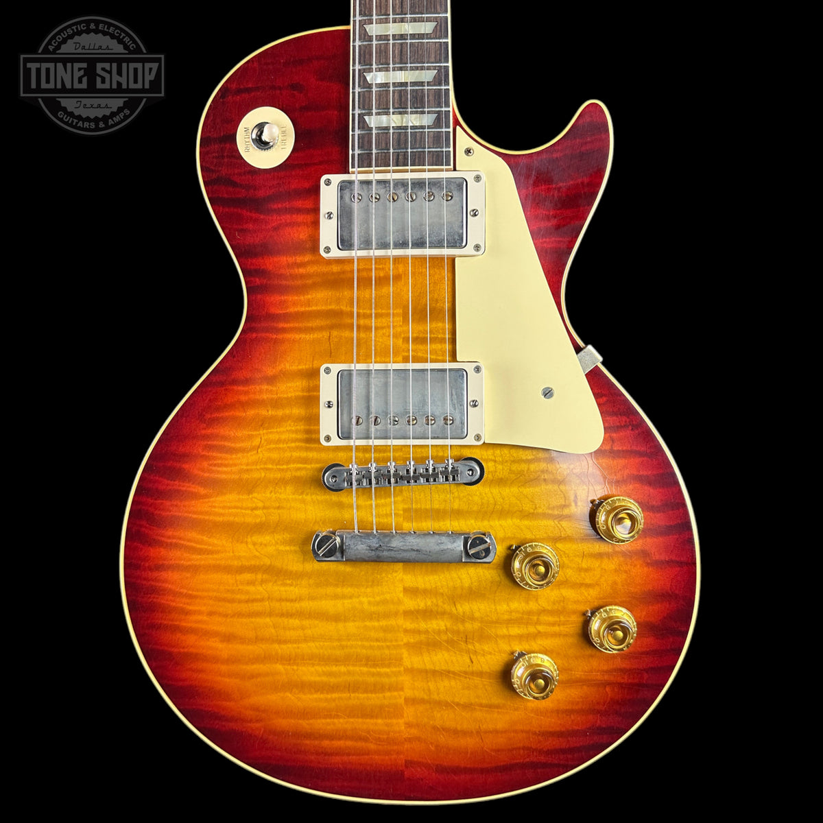 Electric guitar with a sunburst finish on a black background, featuring the Tone Shop logo.