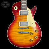 Electric guitar with a sunburst finish on a black background, featuring the Tone Shop logo.