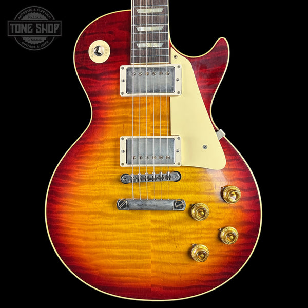 Electric guitar with a sunburst finish on a black background, featuring the Tone Shop logo.
