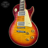Electric guitar with a sunburst finish on a black background, featuring the Tone Shop logo.